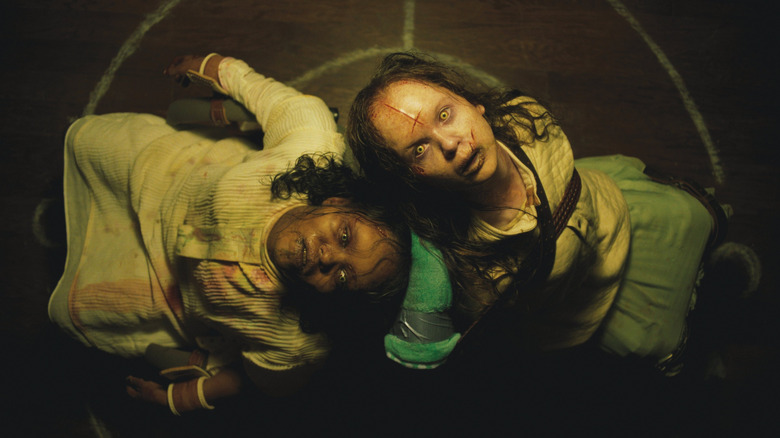 A pair of possessed girls looking up in The Exorcist: Believer