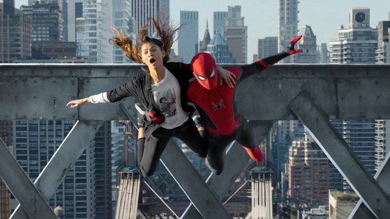 Spider-Man jumps off a bridge holding MJ in "Spider-Man: No Way Home" (2021)