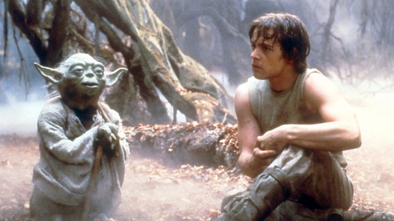 Yoda (Frank Oz) speaking with Luke (Mark Hamill) in the Dagobah swamp