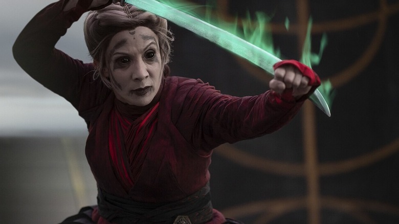 Morgan Elsbeth standing in a fighting stance and wielding blade