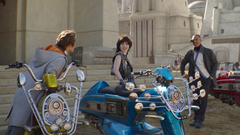 Three of the Mods laughing and standing by building