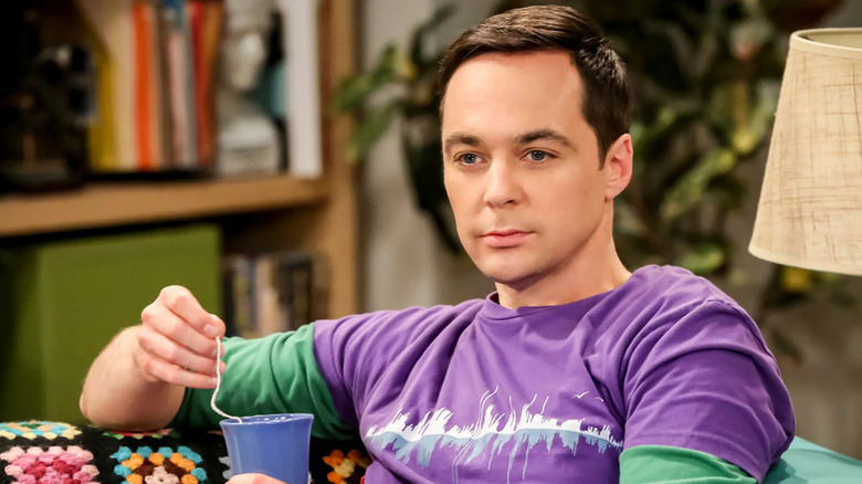 Sheldon drinking tea and staring into the distance on the couch on The Big Bang Theory