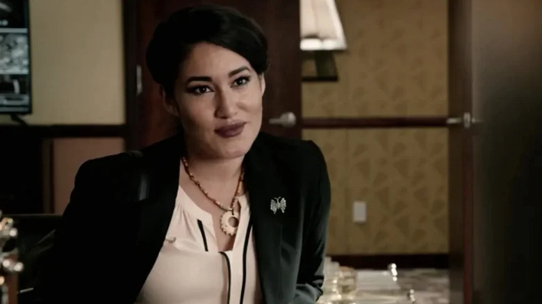 Angela Blue Thunder smirks behind a desk on Yellowstone (2018-2024)