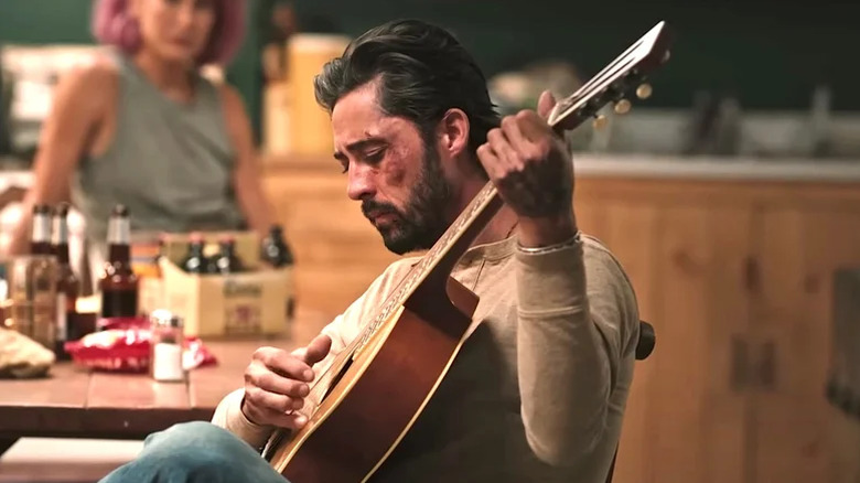 Walker plays his guitar in the bunkhouse on Yellowstone (2018-2024)
