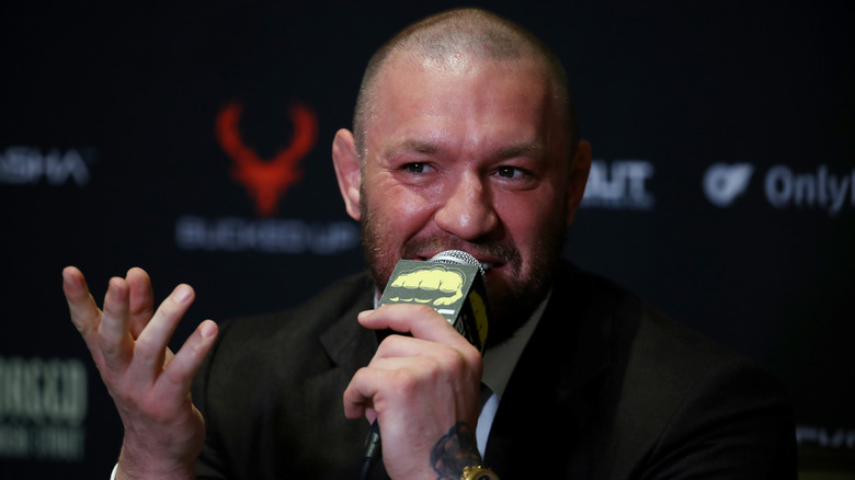 Conor McGregor talking into microphone at event
