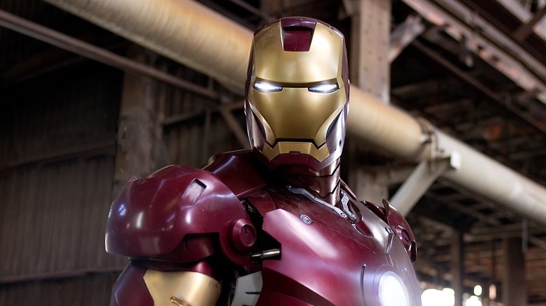 Iron Man standing in an industrial warehouse.