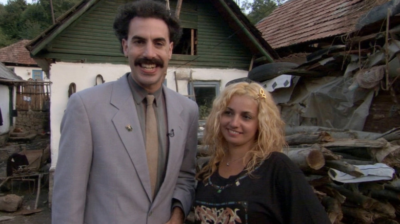 Borat smiling next to his sister in "Borat"