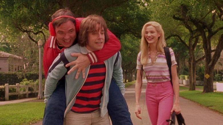 Warren riding piggyback on Ted while Mary watches in "There's Something About Mary"