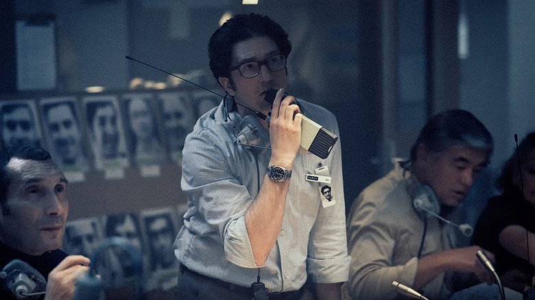 Geoffrey speaking into walkie talkie in "September 5"