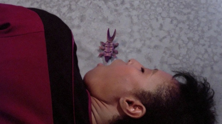 A parasite crawls out of a woman's mouth in Star Trek: The Next Generation