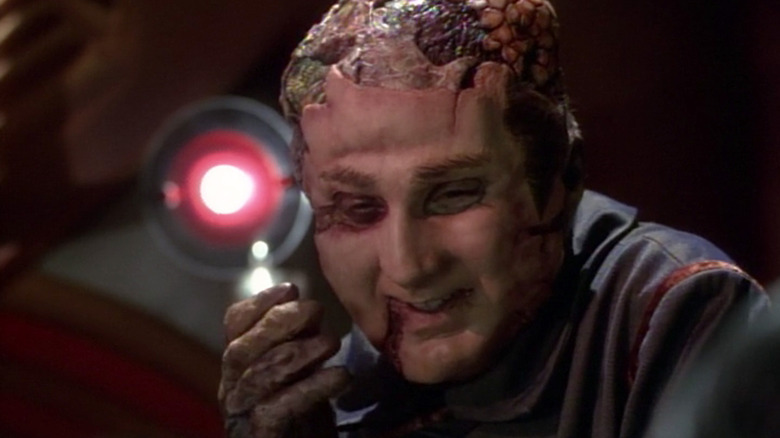 A Vidiian with a human face smiles in Star Trek: Voyager