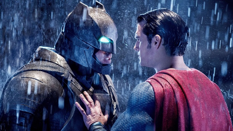 An armored Batman facing off against Superman in the rain in "Batman v Superman: Dawn of Justice"