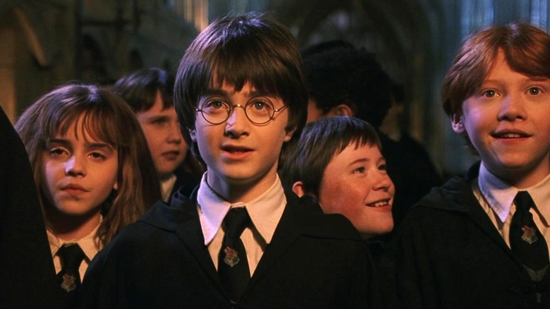 Hermione Granger, Harry Potter, and Ron Weasley staring ahead in Harry Potter and the Sorcerer's Stone
