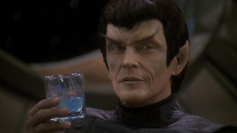 Damar raises a glass in "In The Pale Moonlight"