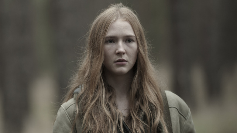 Franziska Doppler standing in the woods with the trees out-of-focus in "Dark" (2017)