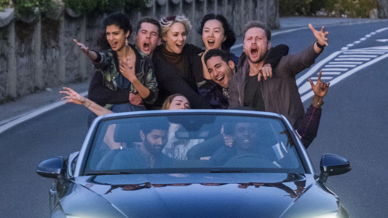 Kala, Will, Riley, Sun, Lito, Wolfgang, Nomi, Rajan, and Capheus all riding in a car cheering in "Sense8" (2018)