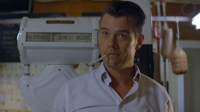 Josh Duhamel as Frank Dunning standing in front of a butcher's scale in 11.22.63