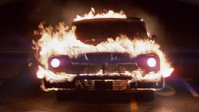 Christine the car in flames, driving toward the camera in Christine