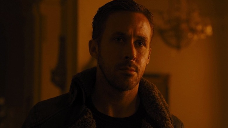 K examining his surroundings in "Blade Runner 2049" (2017)