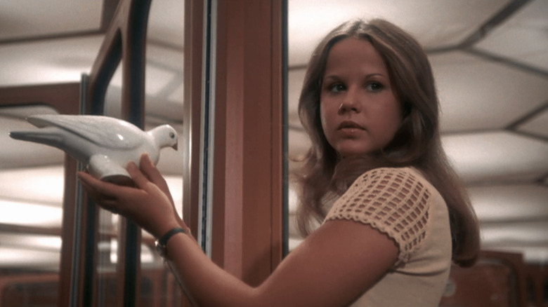 Regan holding a ceramic dove in "Exorcist II: The Heretic" (1977)