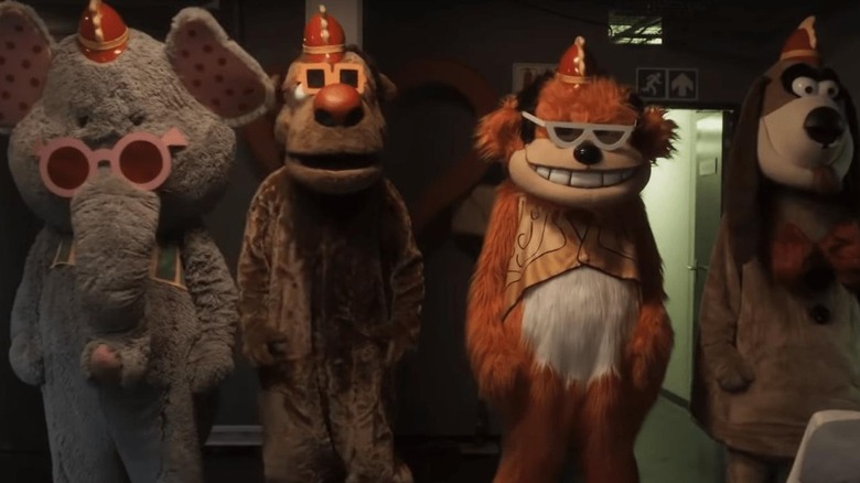 Bingo, Drooper, Snorky, and Fleegle stand ominously in the back studio in The Banana Splits Movie