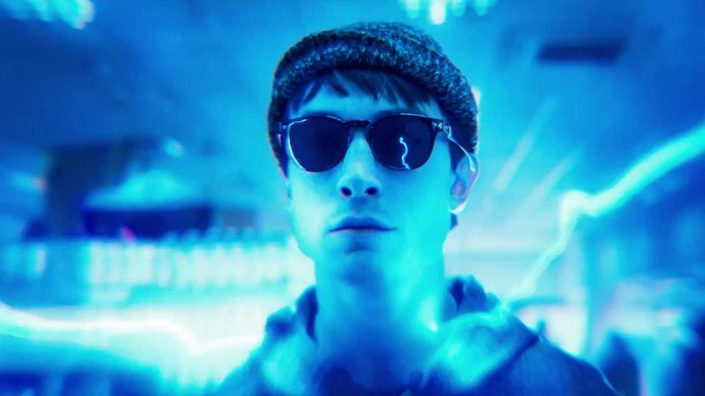 Ezra Miller as The Flash, lit blue by lightning bolts, in The Flash