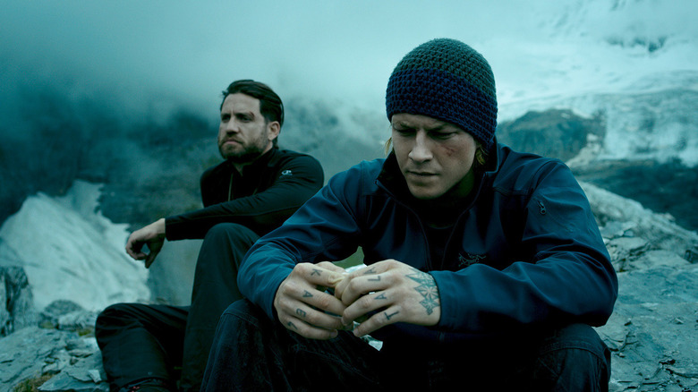 Bodhi and Utah sit on a cliff in "Point Break" (2015)