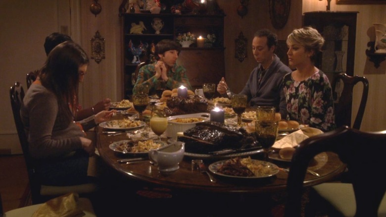 The group sitting at a table full of food in "The Big Bang Theory."