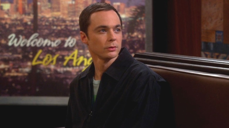 Sheldon sitting in a train station in "The Big Bang Theory."
