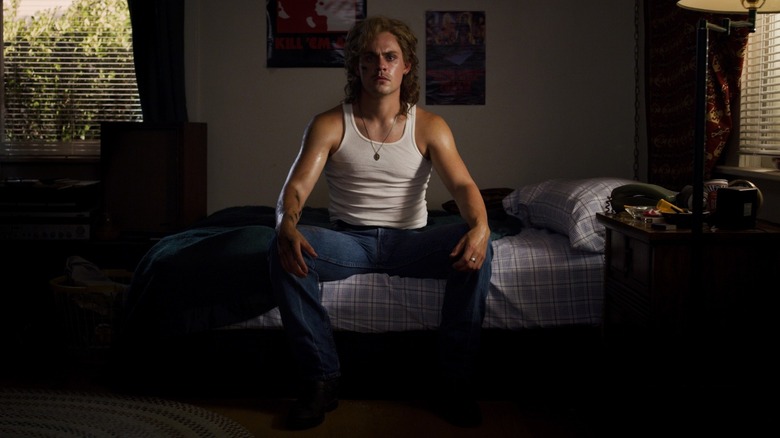 Billy sitting on his bed in "Stranger Things"