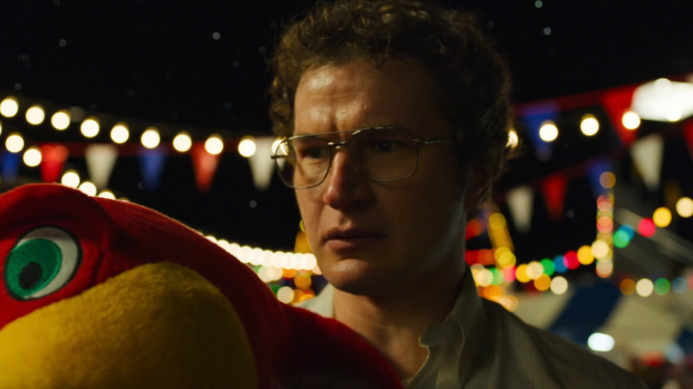 Dr. Alexei holding a stuffed animal in "Stranger Things"