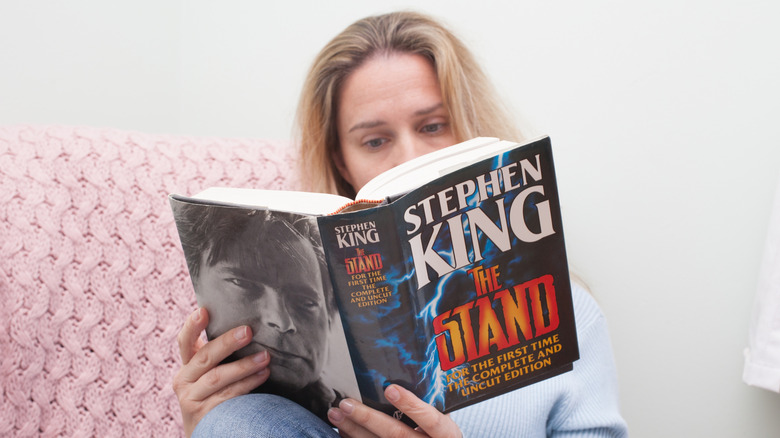 A woman reading Stephen King's The Stand