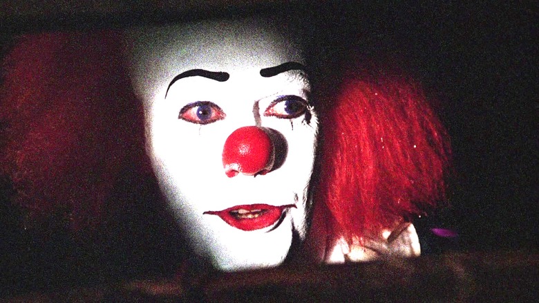 Tim Curry as Pennywise in IT