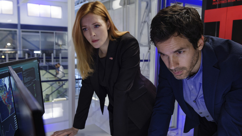 Grace and Darius looking at computer screen in Salvation (2017)