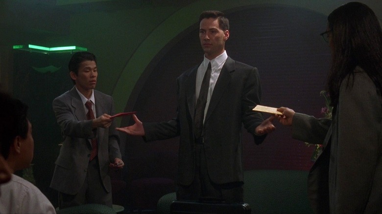 Johnny standing with his arms out in Johnny Mnemonic
