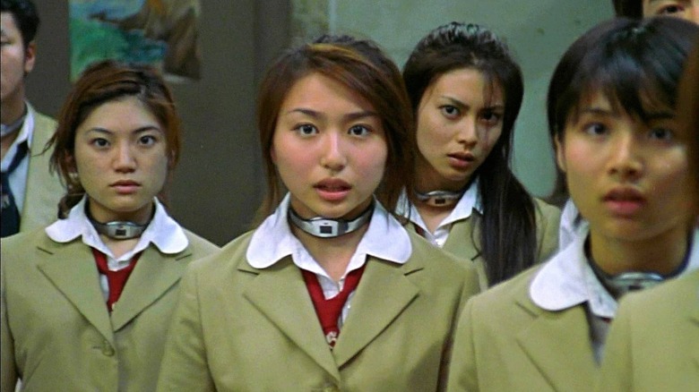 Students in brown jackets with devices around their necks in Battle Royale (2000)