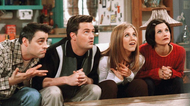 Joey, Chandler, Rachel, and Monica looking up from the couch on 