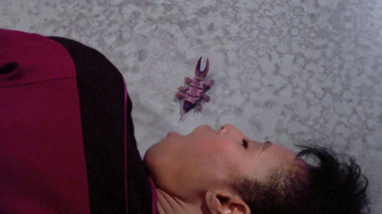 A Parasitic Being laying on the floor next to Tryla Scott's open mouth in "Star Trek: The Next Generation"