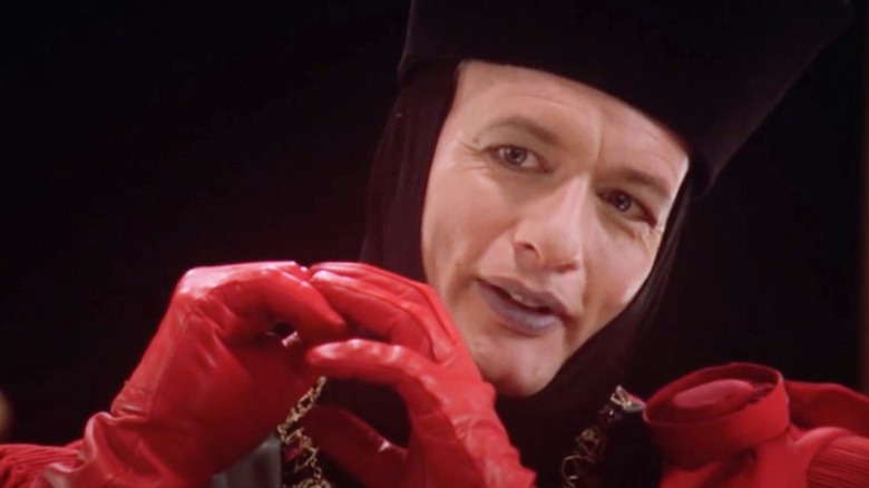 Q smiling in red gloves in "Star Trek: The Next Generation"