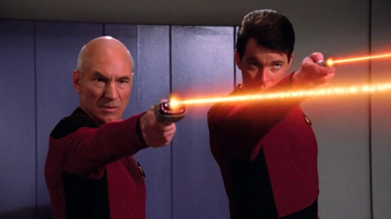 Riker and Picard fire their phasers in Star Trek: The Next Generation
