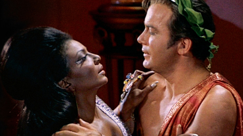 Kirk and Uhura embrace in Star Trek