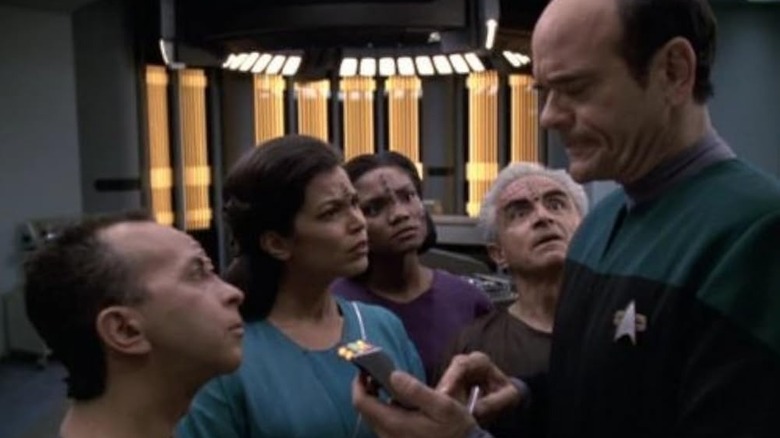 The Doctor talks to a group of Qomar