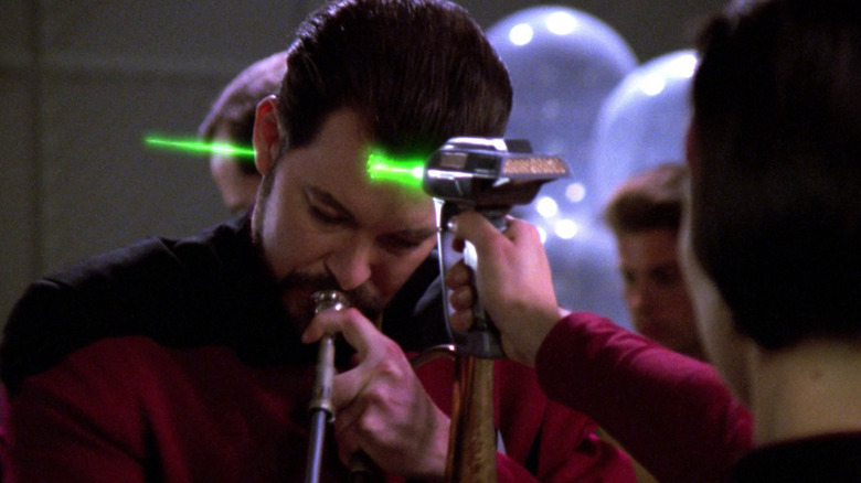 Ro fires a phaser through Riker's head in Star Trek: The Next Generation