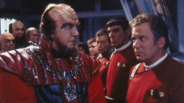 Kirk and crew stand in a line, greeted by the Klingon Chancellor in Star Trek VI: The Undiscovered Country