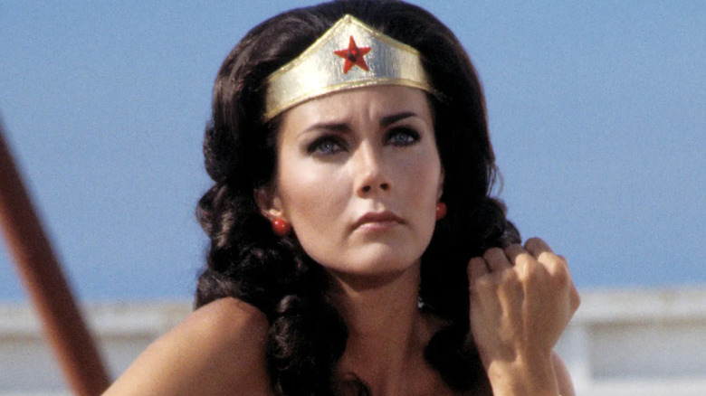 Wonder Woman with her arm up to block a bullet