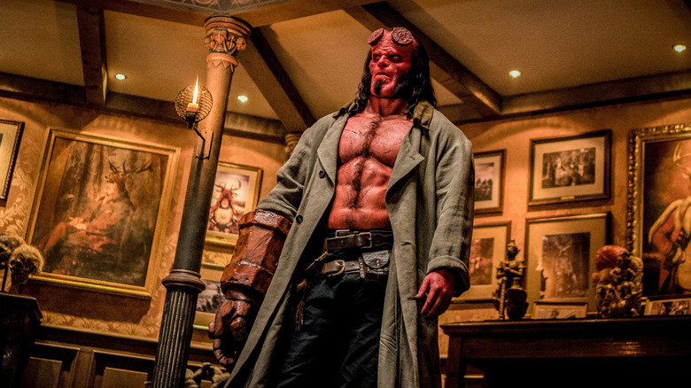Hellboy standing in an art gallery in Hellboy