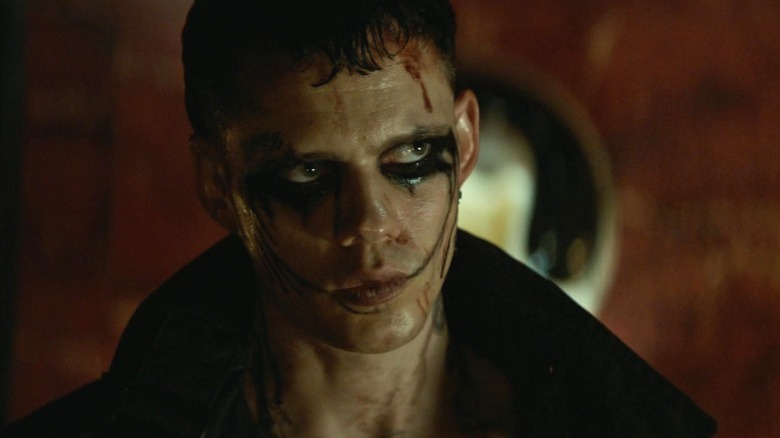 Eric Draven in Crow makeup looking sternly in The Crow