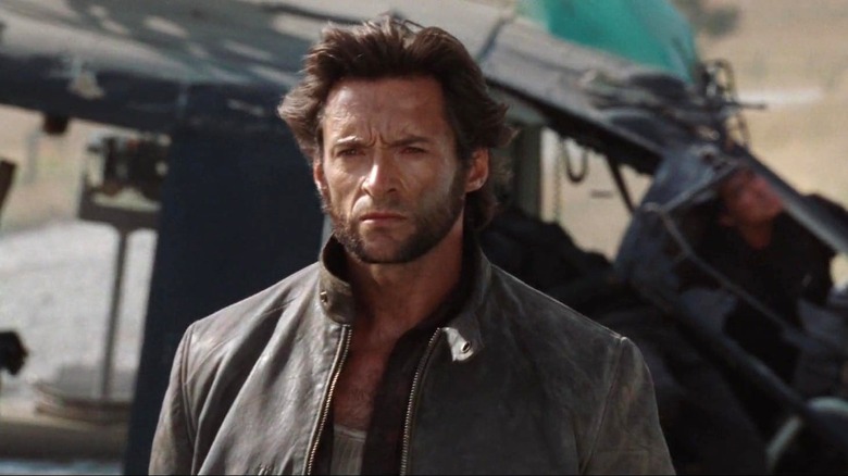 Logan standing in front of a crashed helicopter in X-Men Origins: Wolverine