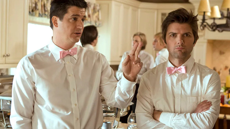 Henry Pollard crosses his arms as Ron Donald holds up his hand while both wear matching white shirts with pink ties in "Party Down"