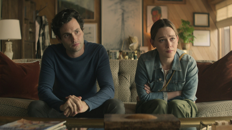 Joe and Love sitting on a couch in "You."